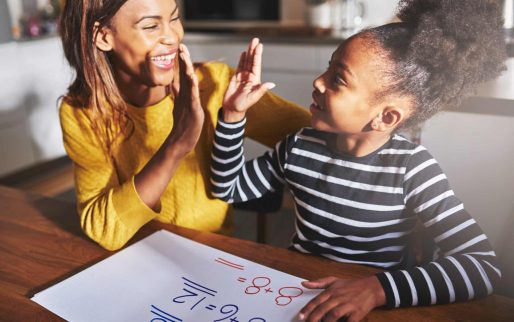 Learning to calculate, high five success, black mother and child