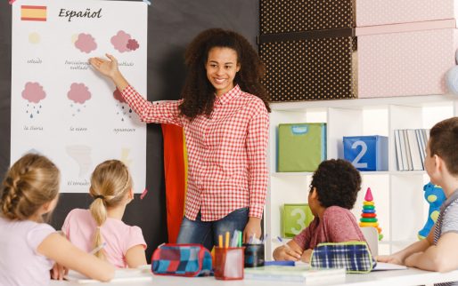 Students learning spanish with teacher in primary school