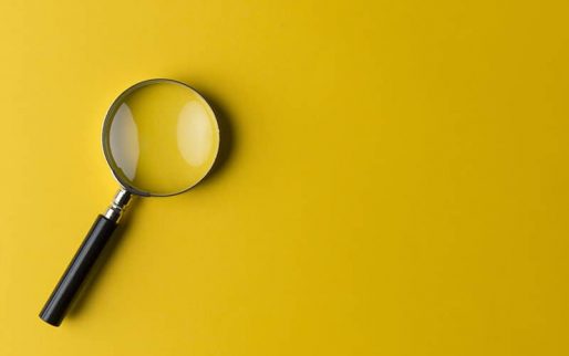 Magnifying glass on the yellow background.