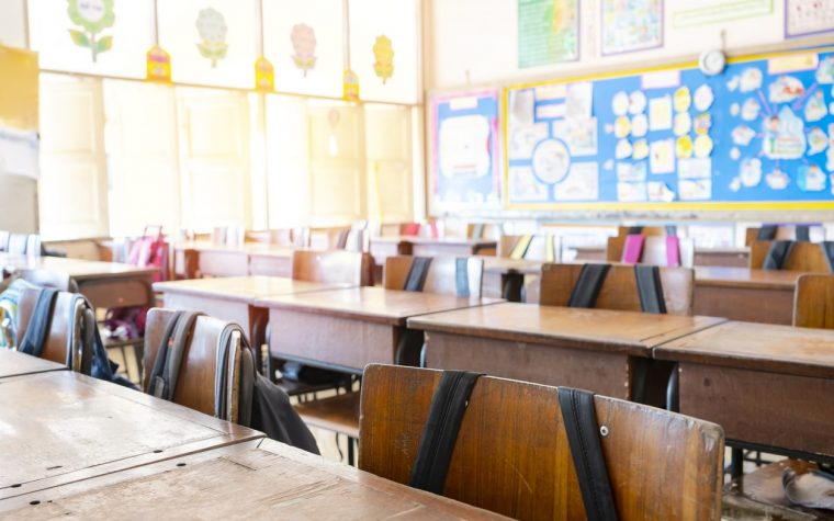 Classroom atmosphere is empty, no students in it. Student chair with student bag hanging, The concept of learning for self-improvement.