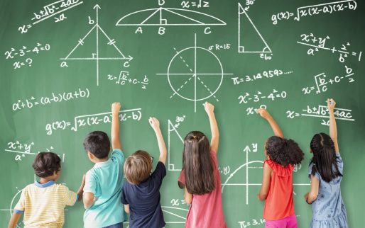 school children drawing math icon on the chalkboard