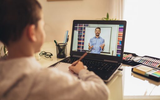 Distance learning online education. A schoolboy boy studies at home and does school homework. A home distance learning.